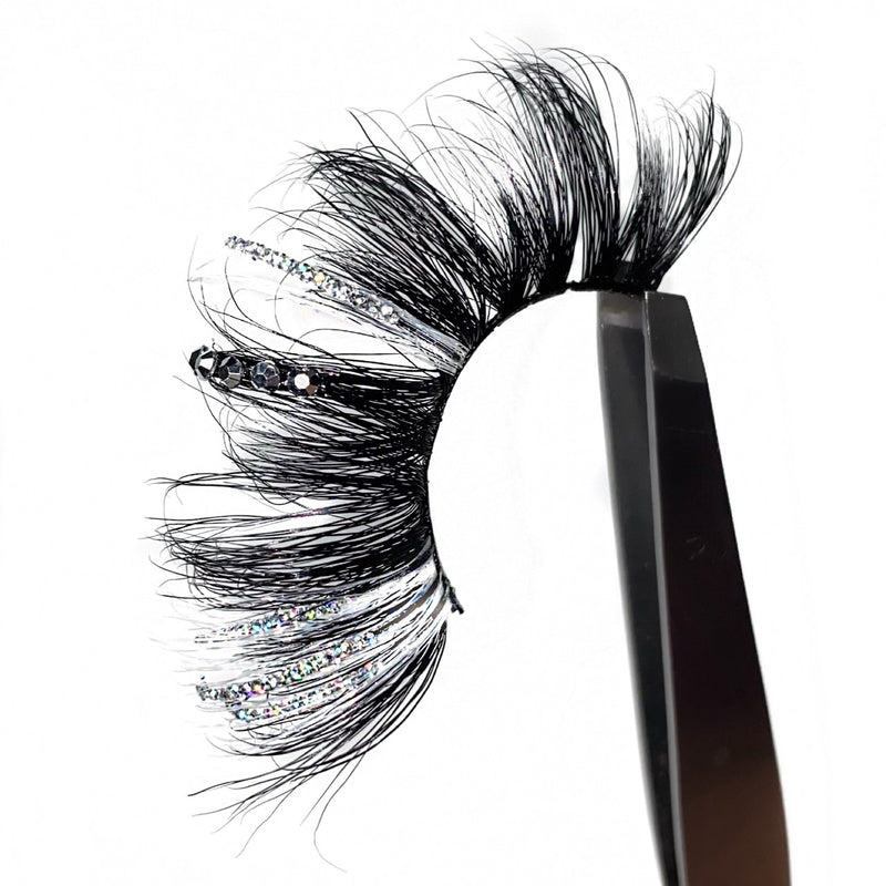 2 Tone White Colored Strip Lashes With A Bling Lash Of Rhinestones And Silver Glitter. This Amazing Eyelash Is Perfect For You To Lash Out In All Your Makeup Looks. A Fancy Lash For Parties And Cosplay.